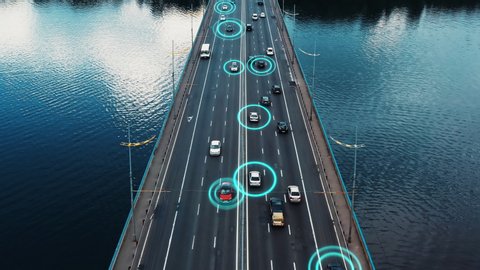 4K aerial drone footage self-driving autopilot cars driving with traffic passing-by on highway on the bridge. Artificial intelligence innovation detecting cars showing speed and driver's ID. Concept
