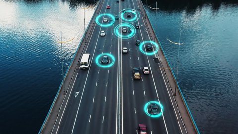 Self driving autonomous cars speeding through the bridge with technology scanning their speed. Artificial intelligence traffic surveillance system to provide safe driving avoid traffic jams. 4K aerial