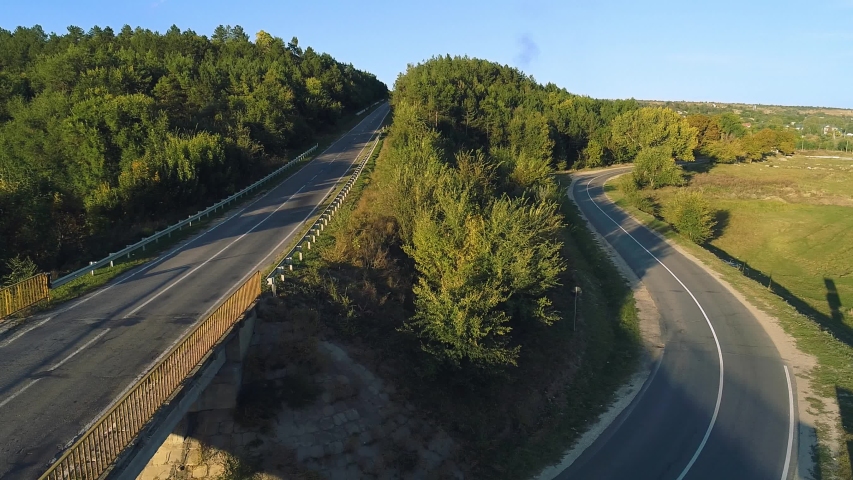 Aerial view of a highway road amidst a forest.