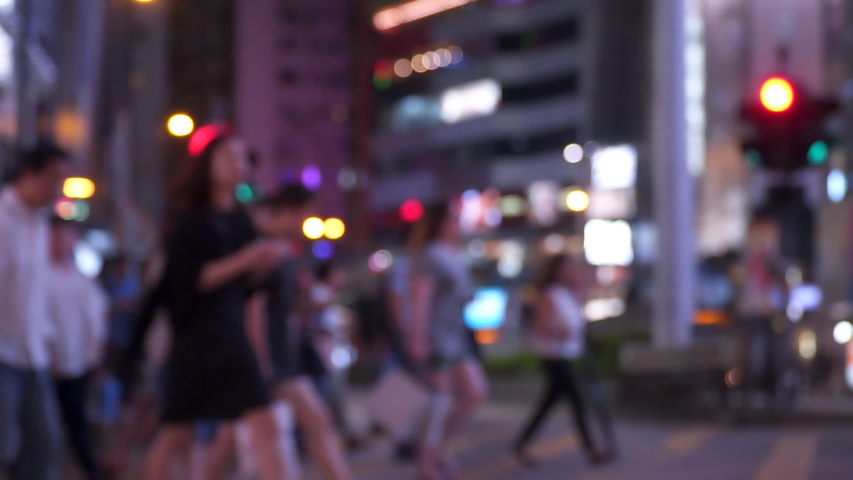 Anonymous crowd of pedestrians cross a busy city intersection on a summer evening. Pedestrians walkers. Urban lifestyle background. Slow motion shot Royalty-Free Stock Footage #1034296247