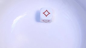 A single white poker dice (die) bounces and rebounds in slow motion on a white background before resting at the symbol for Diamonds. - Powered by Shutterstock - Get 15% off with code: PIKWIZARD15