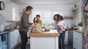 Family Returning Home From Shopping Trip Using Plastic Free Bags Unpacking Groceries In Kitchen - Powered by Shutterstock - Get 15% off with code: PIKWIZARD15