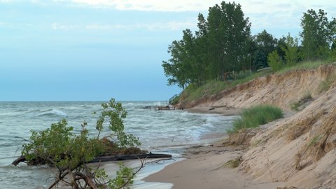Clip showing waves and significant beach erosion on Lake Michigan. High water levels and wave action have reduced beach size across the Great Lakes. Recorded at Little Sable Point in Michigan.