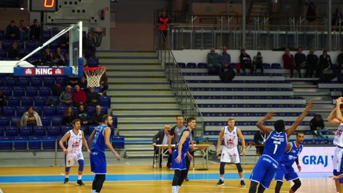 Szczecin / Poland - 01 07 2019: Basketball player jumps slow motion & makes basket indoors gym.