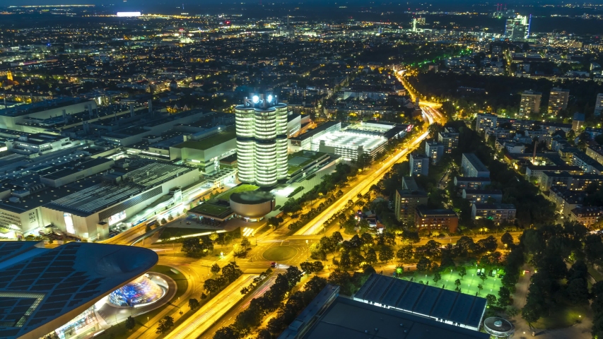 Munich skyline aerial view at night view from top time lapse, germany bavaria. BMW world buildings at night.BMW Museum and BWM Welt and factory in Munich from Olympic Tower