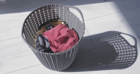 Dirty cloth falls to a laundry basket