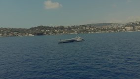 Beautiful yacht in the blue sea off the coast of France Monaco city town Monte Carlo Drone flight port yahts sea flats