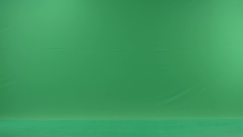 business woman is talking on her mobile cell phone and walking with folders. She wears formal dress: white shirt and blak trousers. Businesswoman Businesswoman think, got idea over green screen