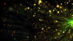 Magic Particles. This stock motion graphics video shows colorful particles exploding slowly on a black background.