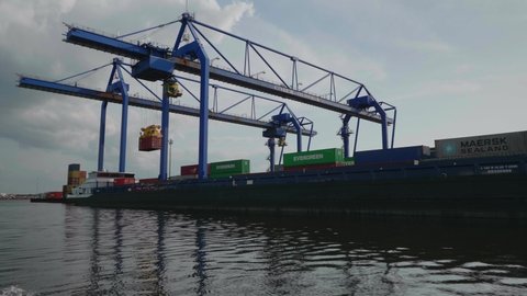 Port of Amsterdam, Noord-Holland/Netherlands -Jul 31-07-19- Inland vessel is being loaded with containers at a container terminal. Containers from Evergreen, Hapag-Loyd, MSC, NYK and Maersk in 4K.