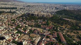 Aerial drone video of iconic Ancient Forum archaeological site and iconic Acropolis hill with masterpiece of Western Ancient world the Parthenon, Athens historic centre, Attica, Greece