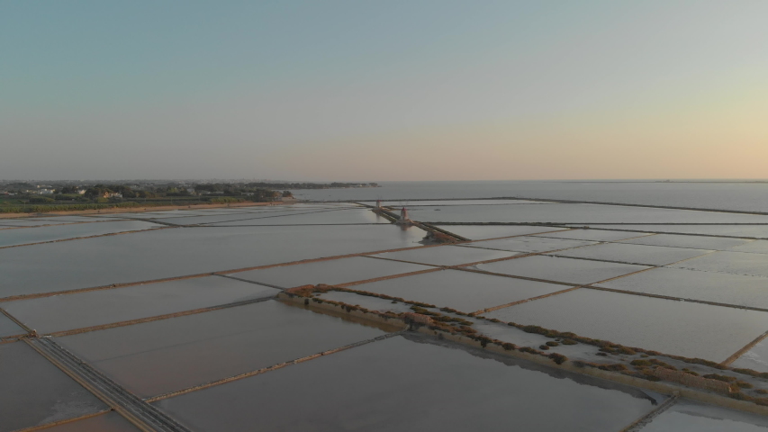 Drone footage of Saline in Sicily, Marsala beautiful coastline in Italy. Wind mills to horizont. 