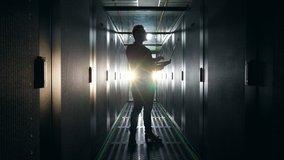 Server room with a backlit silhouette of a male technician. Server Engineer Working at Data Center - Powered by Shutterstock - Get 15% off with code: PIKWIZARD15