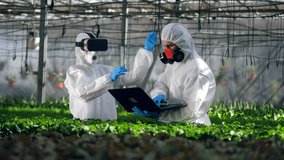Two scientists are holding a digital research in the greenhouse - Powered by Shutterstock - Get 15% off with code: PIKWIZARD15