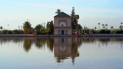Menara Pavilion and Gardens reflected on the lake at sunshine. Marrakech, Morocco.