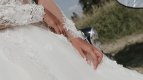 Close-up Of Body Of Young Attractive Bride In Wedding Dress Posing Near Black Vintage Car On Nature On Spring Summer Happy Romantic Day. Fashion Beauty Concept.