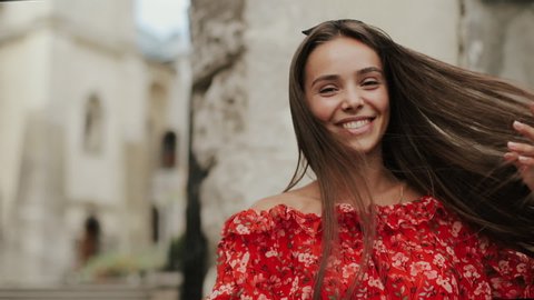 Happy Young Woman With Charming Cheerful Face Having Fun, Dancing, Whirling On Street Of Old Town On Beautiful Spring Summer Day. Millennial Girl Travels To Old Town During Student Vacation Holidays.