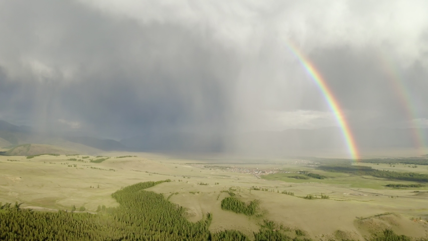aerial view of rainbow in the mountains.