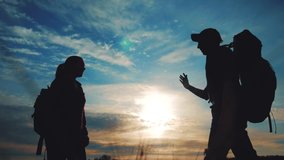 teamwork business journey concept win. team tourists man and woman sunset silhouette lifestyle help shake hands success victory. slow motion video. tourism husband and wife on top of the mountain have - Powered by Shutterstock - Get 15% off with code: PIKWIZARD15