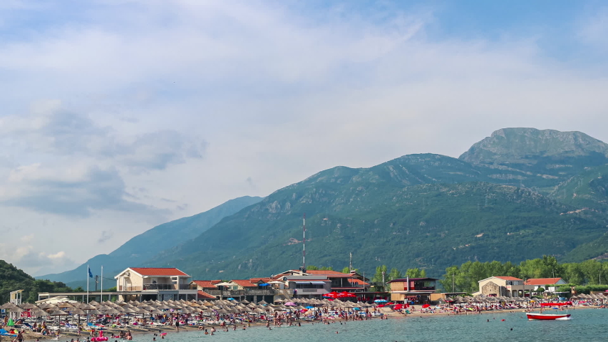Jaz beach surrounded by mountains on the Adriatic sea coast, Montenegro, time lapse panoramic motion