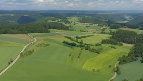 Aerial view of the Black forest and fileds around Dürrenmettstetten in Germany. Pan to the left across woodland and fields.