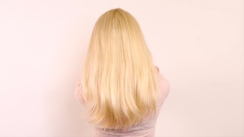 Beautiful long blond Hair. Beauty woman with luxurious straight white hair. Sexy blonde Model girl with Healthy Hair. Lady with long hairstyle. Cure, extensions. Over white background. 4K slow motion