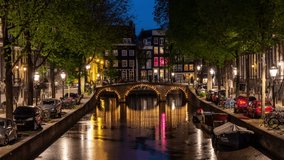 Illuminated canal bridge in old city center of Amsterdam, Netherlands. Time lapse video.