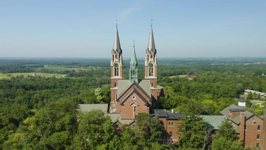 Holy Hill National Shrine of Mary, Wisconsin, USA, aerial forward fly-over through spires drone footage.