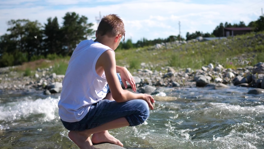 The guy washes himself cold mountain water.Early morning traveller.