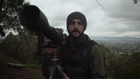Portrait of a professional wildlife photographer outdoors.  Shot in 4K UHD resolution.