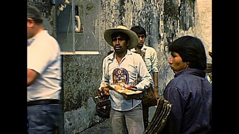 CUERNAVACA, MEXICO - circa 1970: Mexican vendors on the street by the Church of Nuestra Senora de Guadalupe or Our Lady of Guadalupe. Bell tower and dome. Archival of Mexico in South America in 1970s.