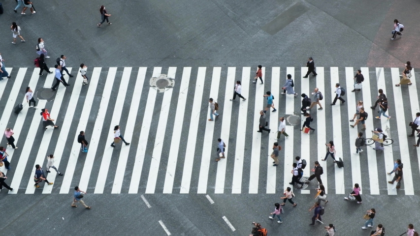 Aerial view of pedestrians walking at Shibuya Crossing. The scramble crosswalk is one of the largest in the world. Shibuya, Tokyo, Japan. Royalty-Free Stock Footage #1034411039