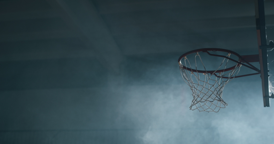 Cinematic slow motion shot of an young african professional male player is making a  slam dunk during a basketball work out in a gym. Royalty-Free Stock Footage #1034419625