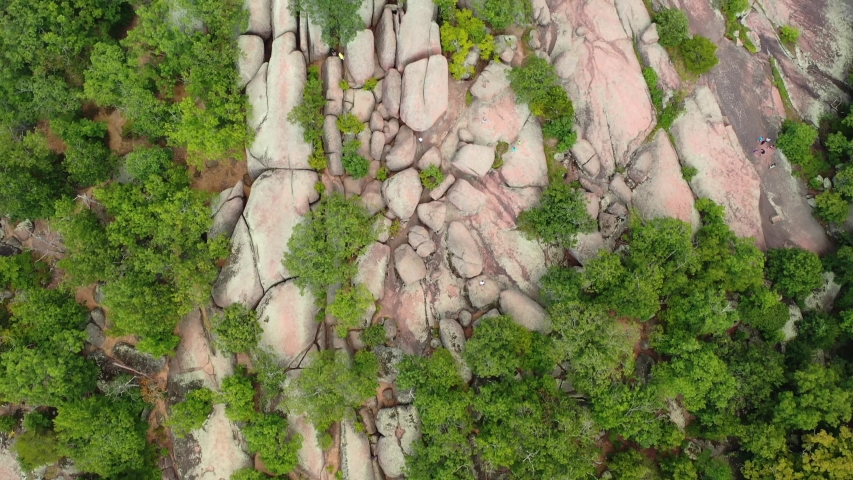 People climbing rocks on beautiful sunny day. Aerial birds eye view