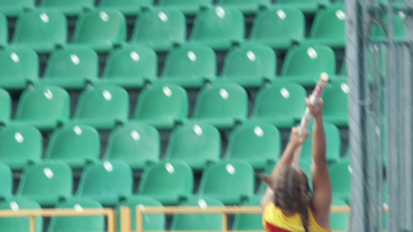 Pole vault - A young sportswoman jumps over the bar