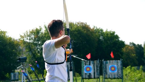 A man is preparing to shoot from the bow. Archery shooting.