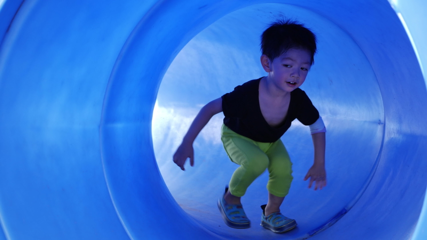 cute boy cheerful playing in playground
