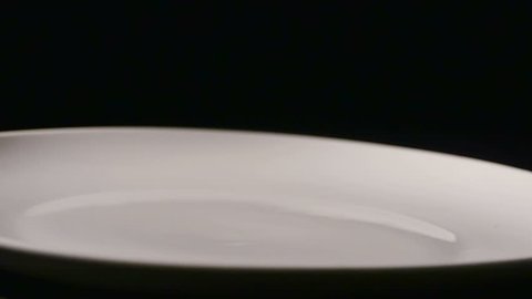 Rice Falling in Slow Motion onto White Plate