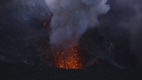 Slow motion high angle of volcano erupting lava