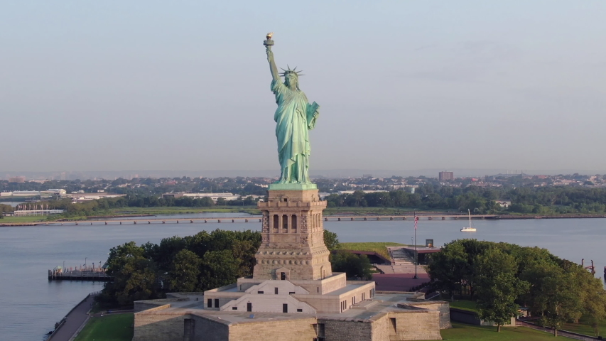 Straight pull away descending aerial Statue of Liberty; cinematic; sunny morning; 4k | Shutterstock HD Video #1034447696