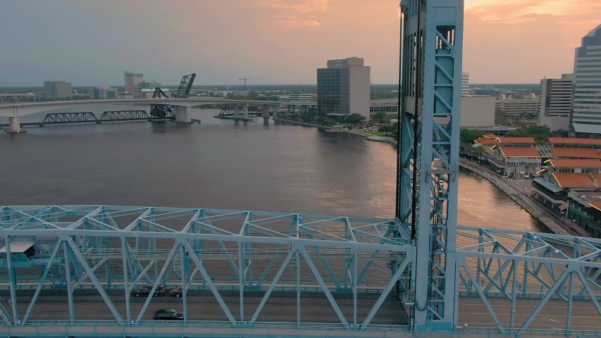 Aerial: Establishing shot of Jacksonville, st Johns river & John T Alsop Jr bridge at sunset. Florida, USA. 2 July 2019 