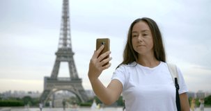 mature woman makes selfie against Eiffel Tower slow motion