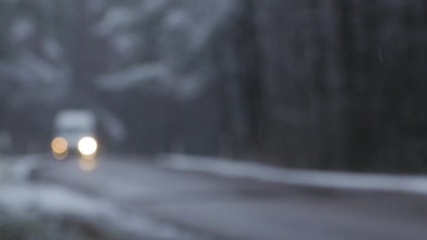 Car driving on winter snow forest road. Focus pull.