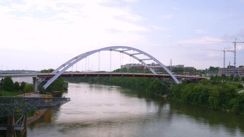 Time Lapse of boats on the Cumberland River under bridge in Nashville, Tennessee