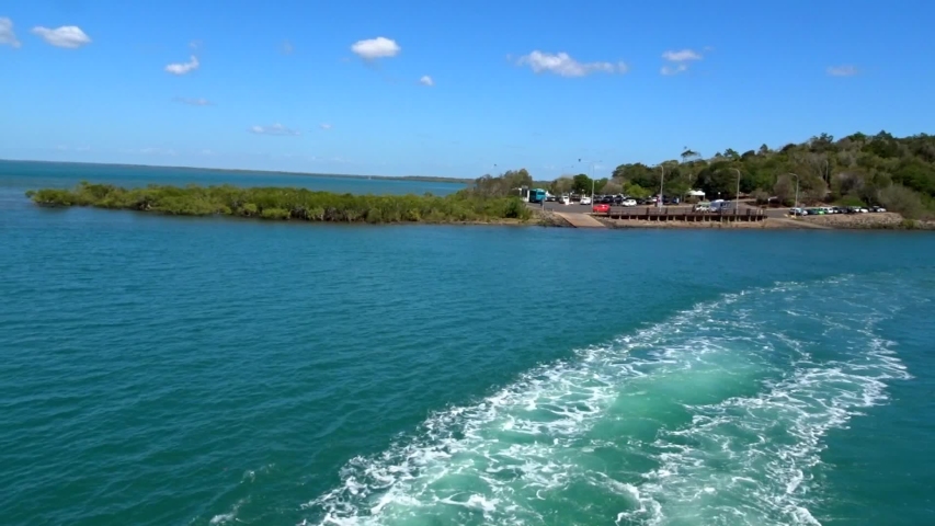 Ferry leaving port, deep blue water.