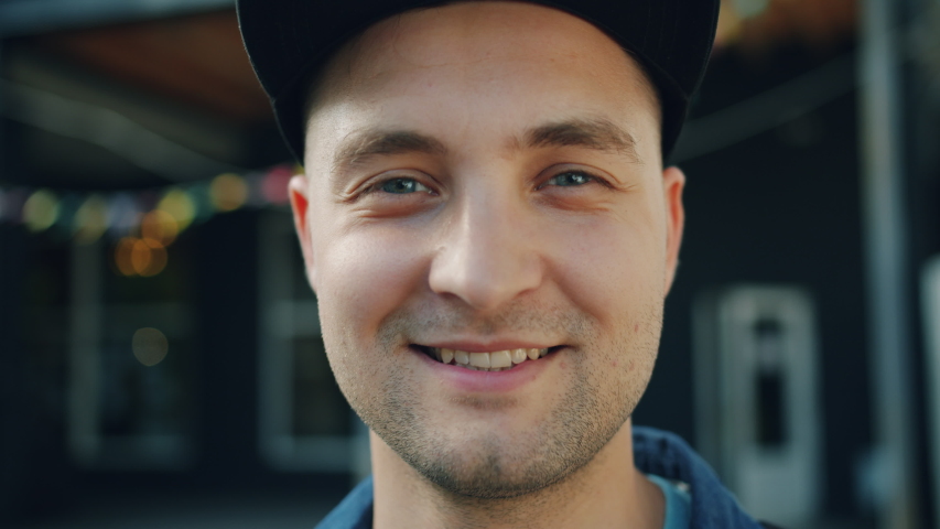 Close-up portrait of attractive adult man smiling standing outdoors in street and looking at camera with happy face. People, emotions and youth concept. Royalty-Free Stock Footage #1034469056