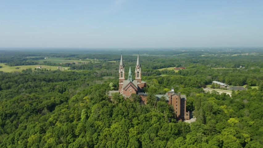 Holy Hill National Shrine of Mary, Wisconsin, USA, aerial view with flying forwards through the spires, drone footage.