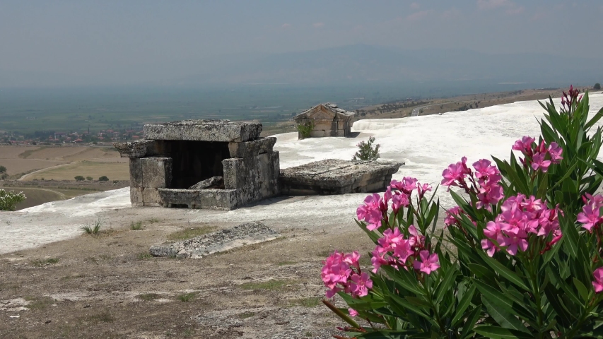 Pamukkale, Denizli, Turkey - 16th of July 2019: 4K Ancient tombs remains on the travertine terraces
