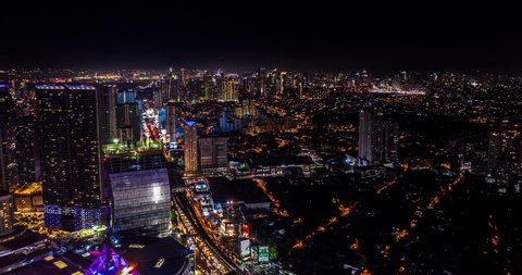 Aerial hyperlapse of Manila downtown skyline at night, from a drone. 4k footage