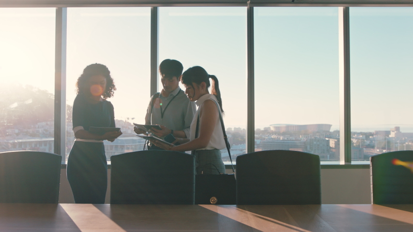 Business people shaking hands consultant meeting international clients greeting with handshake planning partnership deal female executive working with shareholders in corporate office at sunset | Shutterstock HD Video #1034474534